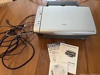 Epson Stylus CX4200 all-in-one printer scanner with cables, manuals, and CD.