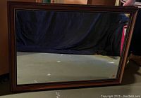 Front view of the framed rectangular mirror showing the full frame and reflective glass.