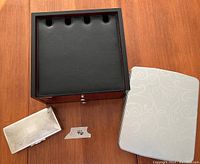 Wooden organizational charging chest, small silver box, and cookie tin shown together on a wood surface.