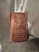 Image shows rectangular copper bar with embossed Native American Indian head and text details on front face.