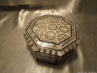 Top angle showing the intricate mother-of-pearl inlay on the octagonal lid and the box shape.