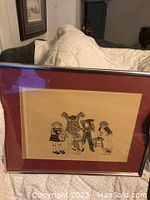 Framed Benchmark print showing the group of children illustration and overall framing condition.