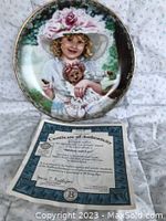 Photo of collector plate showing a young girl in a hat holding a teddy bear along with the Certificate of Authenticity
