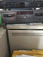 Black JVC stereo cassette deck front panel showing tape slot, transport buttons, calibration controls