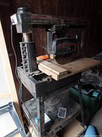 Full view of Sears Craftsman radial saw showing saw arm, base, and cutting blade mounted on it with dust and signs of unused condition.