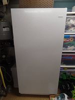Front view of closed freezer showcasing white textured door and Frigidaire badge