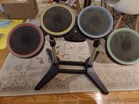 Front view of the Wii drum kit showing four color-coded drum pads mounted on a stand.