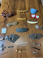 Full overview of all 18 hair clips and adornments arranged on wooden surface.