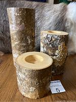 Three Aspen wood candle holders displayed with natural bark and carved top cavity for votive candles.