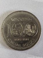 Front side view of the 1874-1974 Winnipeg Centennial Canada Dollar Coin showing detailed engravings and text.