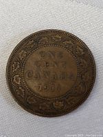 Reverse side of the 1911 Canadian one cent coin displaying denomination, year, and maple leaf wreath design.