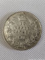 Reverse side of the 1911 Canadian 10 cents silver coin showing denomination, date, maple leaf wreath and crown.