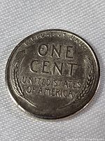 Reverse of 1943 zinc Lincoln wheat penny showing denomination and wheat ears.