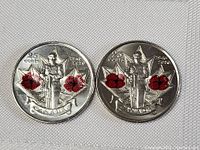 Two Canadian quarters featuring the Remembrance Day design with a soldier and two red poppies, dated 1945 and 2010, front view.