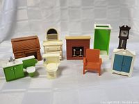 Full lot of 1970s dollhouse furniture pieces against white backdrop, showing all items.