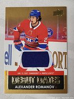 Front image of the Alexander Romanov game used jersey card showing player in red Canadiens jersey and blue patch from jersey.