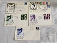 Photo showing six First Day Covers with colored Queen Elizabeth II stamps in blocks and singles, addresses and cancellations visible.