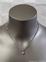 Full view of the 16-inch twisted rope chain necklace with pendant on display bust