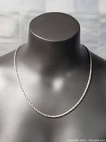 Full view of the sterling silver thick braid necklace displayed on a black mannequin bust showing the overall length and design.