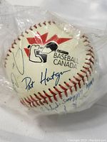 Photo of the sealed Baseball Canada official baseball showing Baseball Canada logo and facsimile autographs including Pat Hutgna.