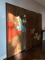 Full view of six-panel Asian room divider screen leaning against wall, showing the joined panels with partial figures.