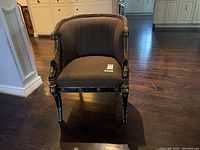Front view of armchair showing overall style, upholstery and frame