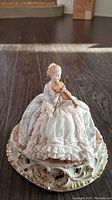 Front view of the Fabris porcelain figurine depicting Lady Evelyn playing the violin, showing detailed dress and violin.