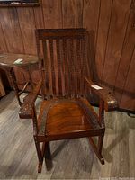 Front view of wooden rocking chair showing full silhouette and carved front details