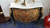 Front view of chest showing Boulle marquetry and ormolu mounts