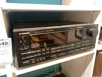Front view of Pioneer VSX-9300 stereo receiver showing the display screen and control buttons.
