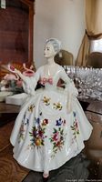Front view of Royal Doulton 'Diana' porcelain figurine showing floral pattern and pink bow on dress.