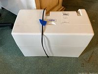 Closed white plastic carrying cover with handle and Brother logo