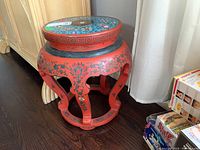 Full view front angle of the red lacquer round table showing overall shape and design