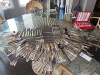 Full overview of flatware and chargers on table
