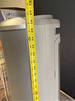 Side profile of the silver and white Bionaire PermaTech air cleaner with measuring tape showing height about 27 inches.