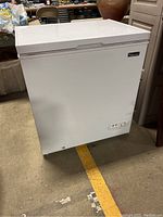 Image of the closed white Magic Chef chest freezer showing overall condition and size.