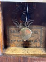 Interior pendulum and label detailing New Haven Clock Co. origin