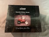 Front view of the Trafel Essentials box showing 'Essential Whisky Stones Elegant Set' and tagline 'Drink Spirits Like a Pro'.