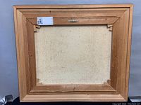 Back view of the painting showing wooden stretcher and frame structure.