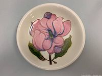 Full top view of the bowl showing the detailed pink flower and green leaves artwork inside the porcelain bowl.