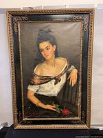 Full view of the framed oil painting showing a woman holding a red rose, with visible wear on frame and painting.