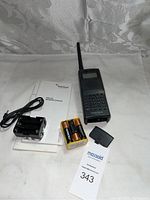 Full lot showing RadioShack PRO-92 handheld scanner, backup battery holder, four AA batteries, manuals, and scanner antenna.