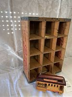 Photo showing wooden crate with visible interior compartments and Pepsi Cola branding on the side