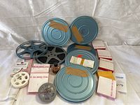 Front view showing all film reels, cans, and packaging arranged on white backdrop