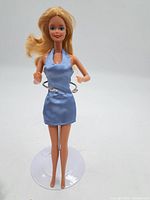 Front view of vintage Baby Spice doll wearing light blue satin dress without display stand.