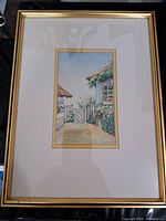 Full view of framed watercolor painting showing verandah scene with plants and pathway.