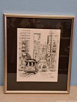 Framed black and white print showing the full artwork and frame with minor wear.