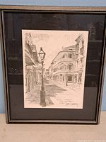 Framed black and white print depicting Royal Street New Orleans, signed and dated by Don Davey in 1976.
