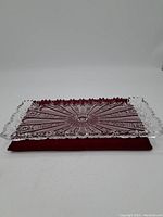 Full view of the vintage rectangular cut crystal tray resting on red fabric, showing the overall shape and intricate cut design.