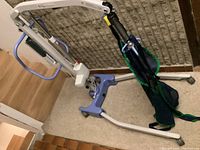 Front angle view of the Joerns Hoyer Advance 340 patient lift with sling attached, showing frame and base